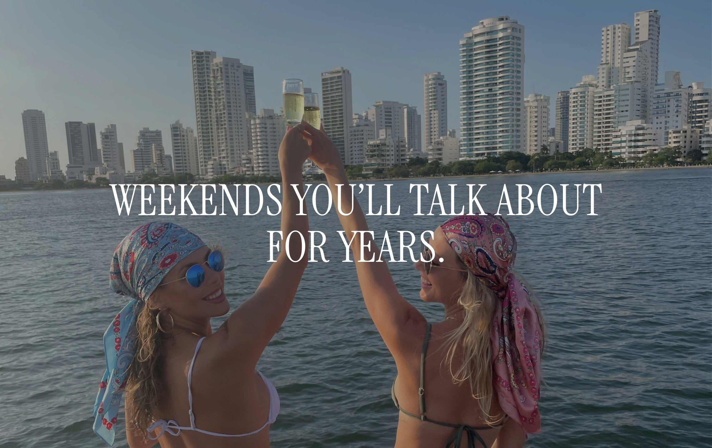 Two women toasting champagne drinks on a boat in Cartagena Colombia, luxury girls getaway weekend travel inspiration, best friends bff girls trip, bachelorette weekend trip