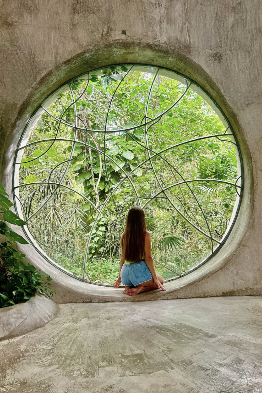 Woman sitting inside circular jungle window at SFER IK Azulik Tulum, luxury girls trip travel destination inspiration